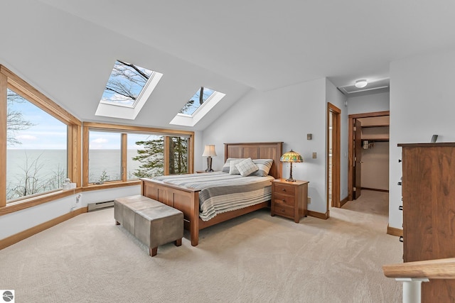 bedroom featuring baseboards, a baseboard heating unit, multiple windows, and light carpet