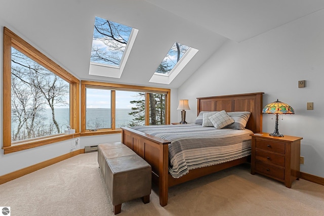 bedroom featuring a skylight, baseboards, a baseboard radiator, and light colored carpet