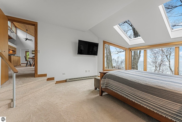 carpeted bedroom with baseboards, lofted ceiling with skylight, and baseboard heating