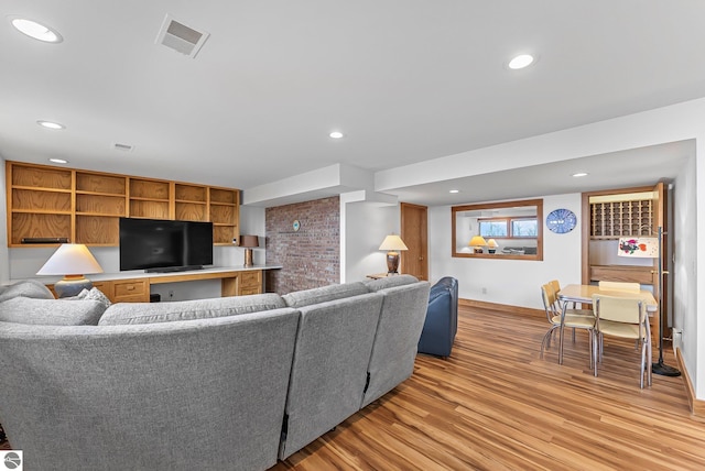 living room featuring visible vents, recessed lighting, light wood-style flooring, and baseboards