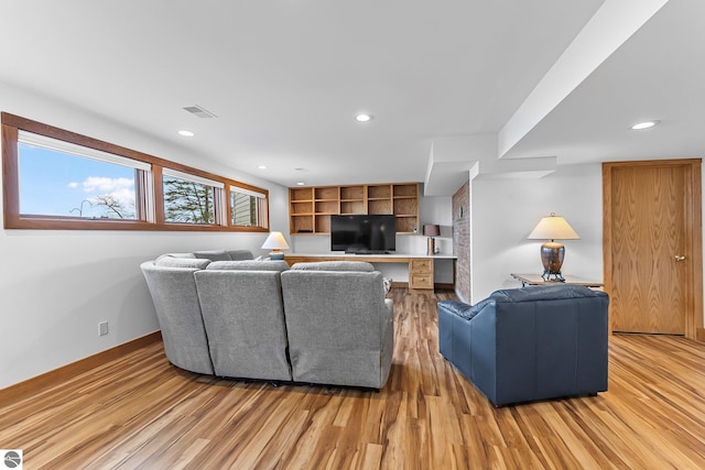 living area with recessed lighting, baseboards, visible vents, and light wood finished floors