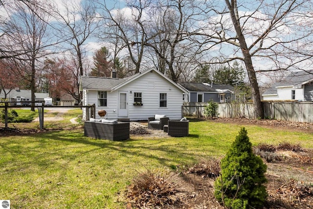 rear view of property with an outdoor living space, a chimney, roof with shingles, fence, and a yard