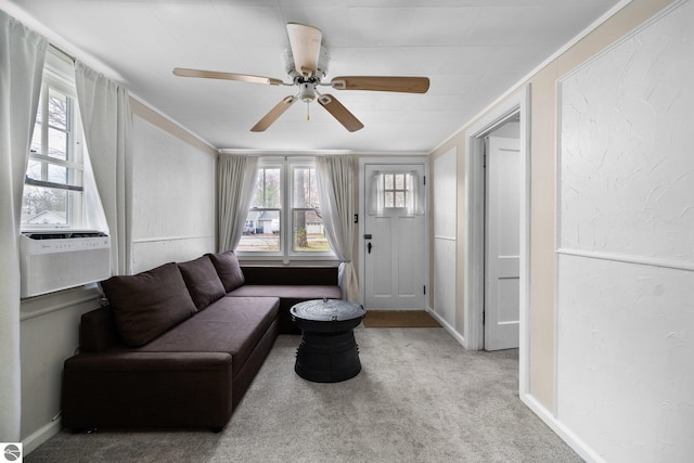 living area featuring baseboards, ceiling fan, carpet, and cooling unit