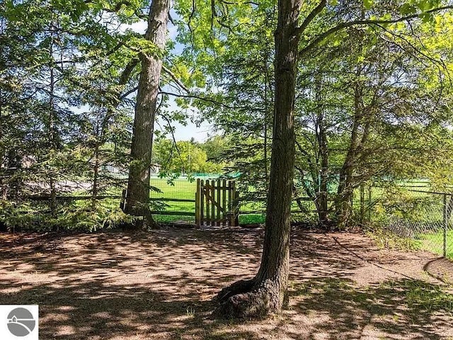 view of home's community featuring fence