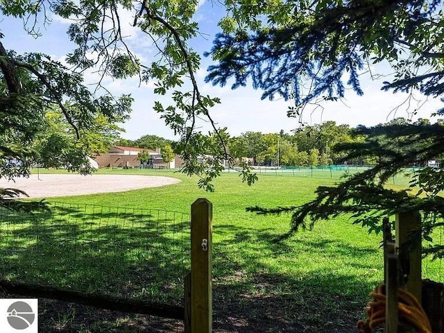 surrounding community featuring a yard and fence