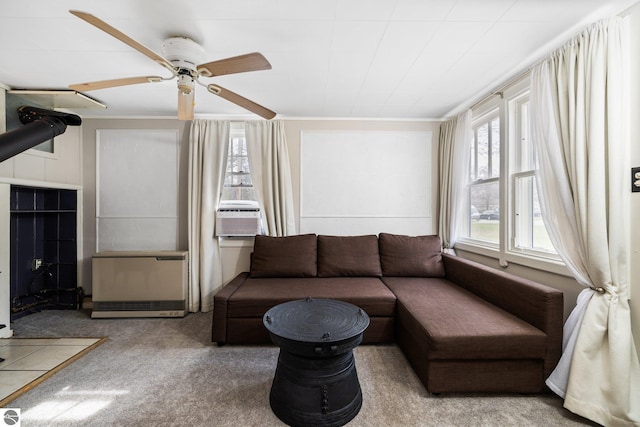 carpeted living area featuring ceiling fan and cooling unit