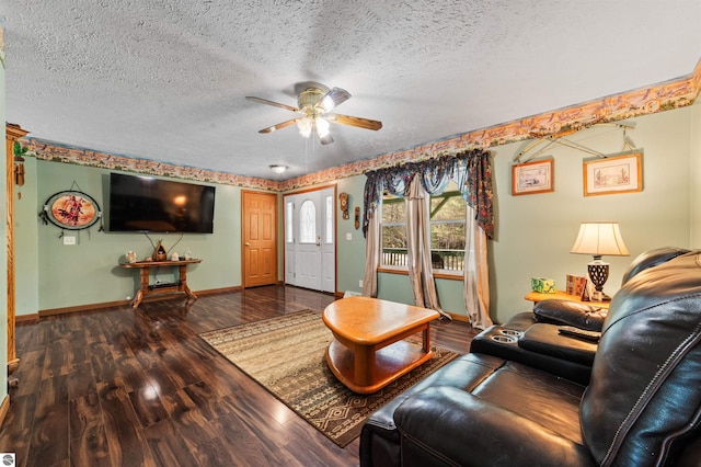 living room with baseboards, a textured ceiling, ceiling fan, and wood finished floors