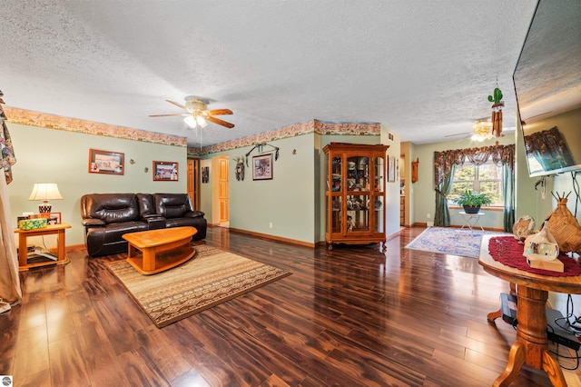 living room featuring baseboards, a ceiling fan, a textured ceiling, and wood finished floors