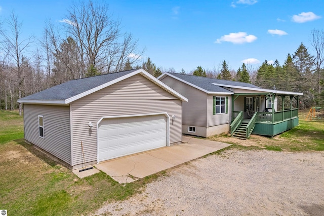 ranch-style home featuring a porch, driveway, and roof with shingles