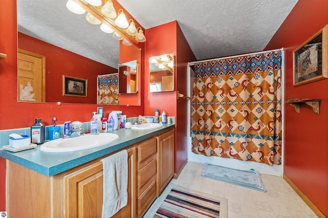 full bathroom with baseboards, a textured ceiling, a sink, and shower / tub combo with curtain