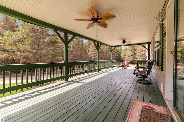 deck with a porch and a ceiling fan