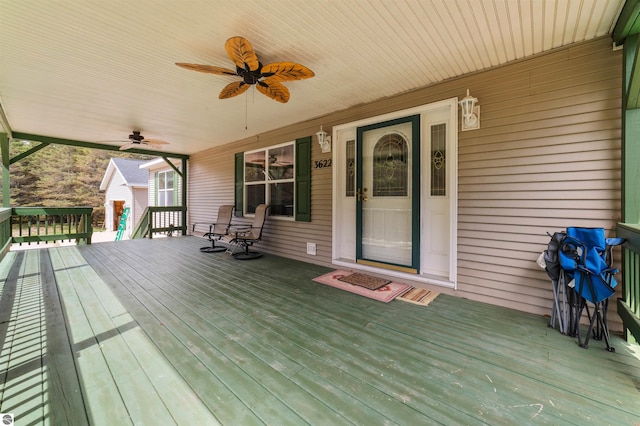 wooden deck with covered porch and a ceiling fan