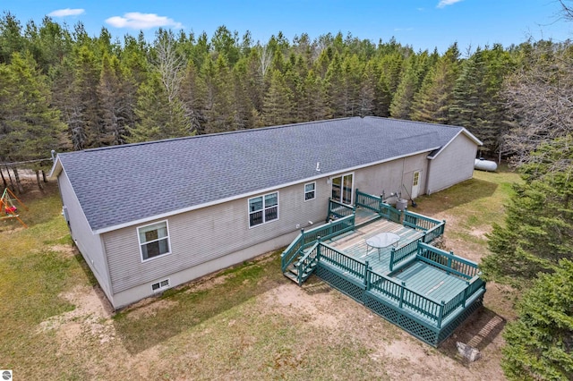 bird's eye view with a wooded view