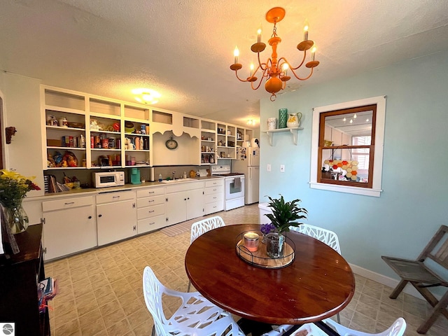 dining room with an inviting chandelier and a textured ceiling