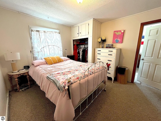 carpeted bedroom featuring a textured ceiling, ornamental molding, and a closet