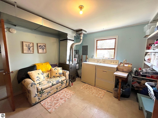 basement featuring washer and clothes dryer, heating unit, electric panel, and electric water heater