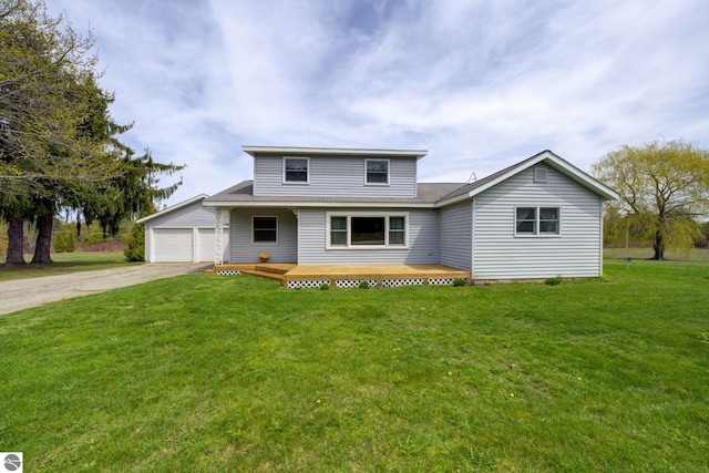 traditional-style home featuring a garage and a front lawn