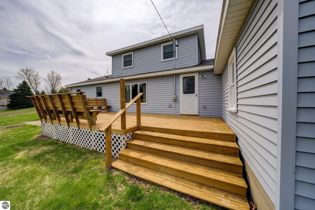 back of property with a yard and a wooden deck