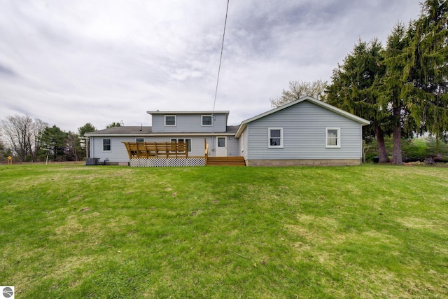 rear view of house featuring central AC unit, a yard, and a deck