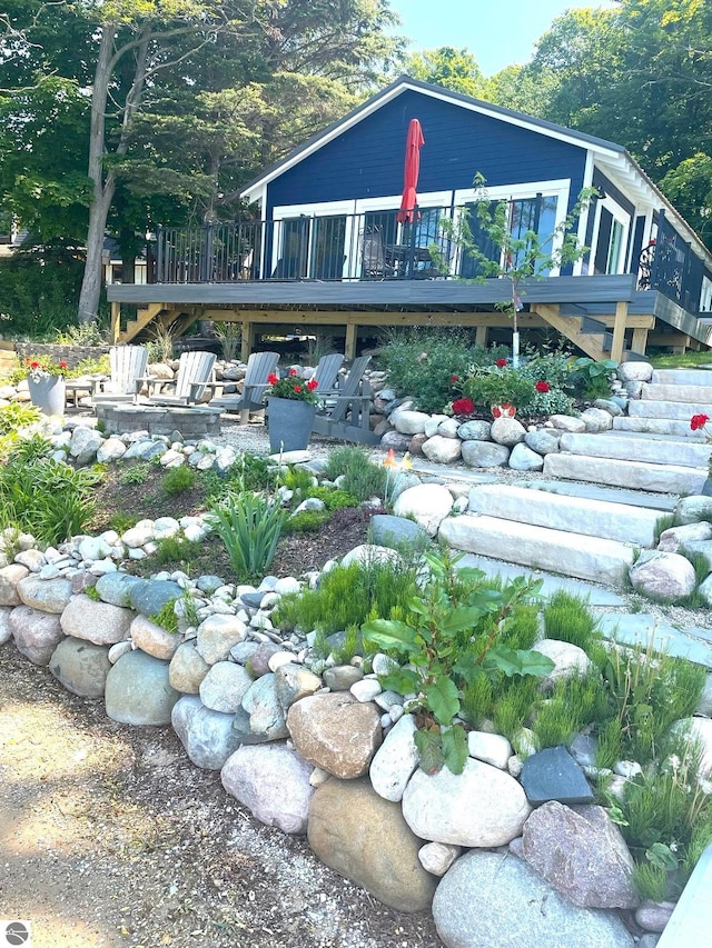 back of house with a wooden deck, stairs, a patio area, and an outdoor fire pit