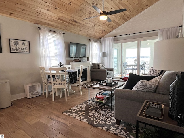 living room featuring wood finished floors, lofted ceiling, baseboards, ceiling fan, and wood ceiling