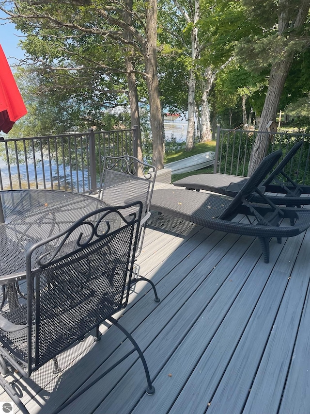 wooden terrace with outdoor dining space