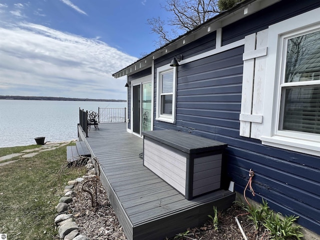 view of side of home featuring a deck with water view