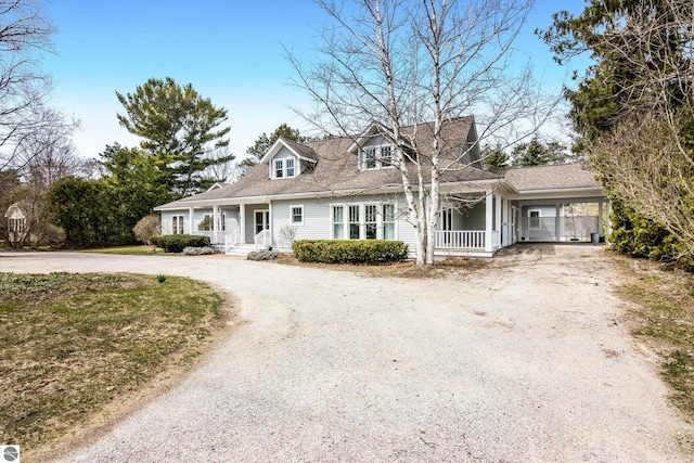 300 S Grand Ave, Leland, MI 49654 - cape cod-style house with curved driveway and a porch