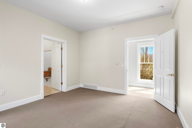300 S Grand Ave, Leland, MI 49654 - carpeted spare room with visible vents and baseboards
