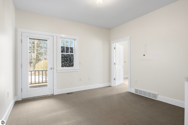 300 S Grand Ave, Leland, MI 49654 - spare room featuring visible vents, carpet, and baseboards