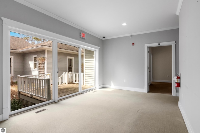 300 S Grand Ave, Leland, MI 49654 - carpeted spare room featuring baseboards, ornamental molding, and visible vents