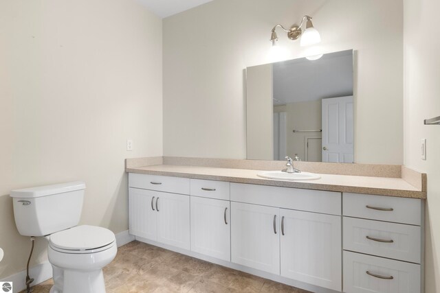 300 S Grand Ave, Leland, MI 49654 - bathroom featuring vanity, baseboards, and toilet