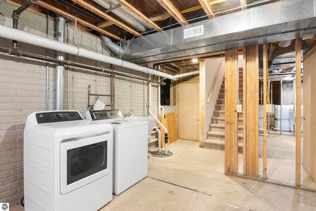 300 S Grand Ave, Leland, MI 49654 - unfinished basement featuring washing machine and dryer, stairs, and visible vents