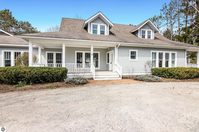 300 S Grand Ave, Leland, MI 49654 - bungalow with a porch and a shingled roof