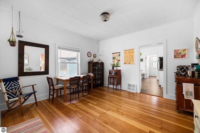 917 Lincoln St, Traverse City, MI 49686 - dining room featuring crown molding, light wood finished floors, and visible vents