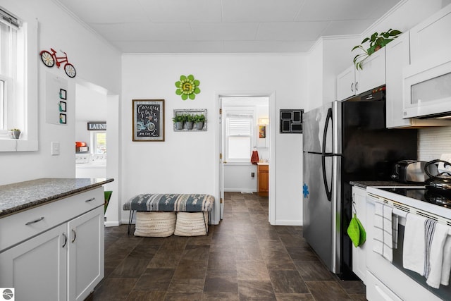 917 Lincoln St, Traverse City, MI 49686 - kitchen featuring plenty of natural light, white cabinetry, crown molding, and white appliances