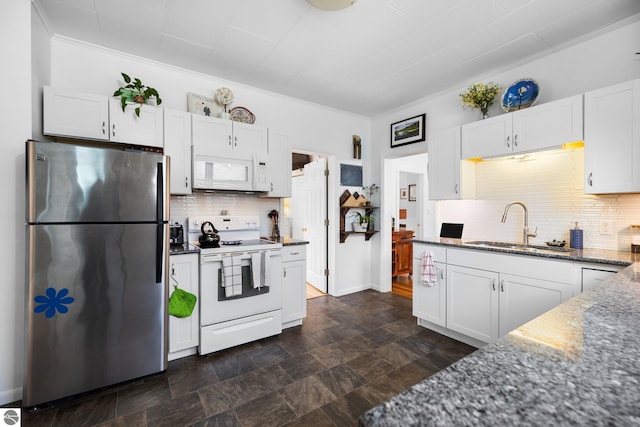 917 Lincoln St, Traverse City, MI 49686 - kitchen with a sink, dark stone counters, white cabinets, and white appliances