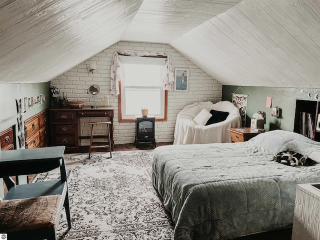 bedroom featuring a wood stove, brick wall, and lofted ceiling