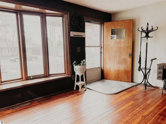 entrance foyer featuring visible vents and wood-type flooring