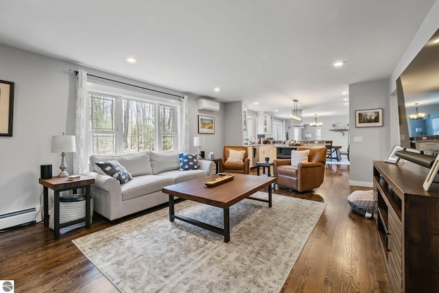 9086 N Tottenham Dr, Traverse City, MI 49685 - living room with an inviting chandelier, baseboard heating, a wall mounted air conditioner, recessed lighting, and dark wood-type flooring