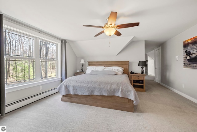 9086 N Tottenham Dr, Traverse City, MI 49685 - bedroom featuring baseboards, ceiling fan, baseboard heating, carpet flooring, and vaulted ceiling