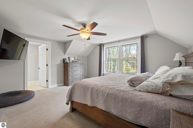 9086 N Tottenham Dr, Traverse City, MI 49685 - bedroom with baseboards, ceiling fan, carpet, and vaulted ceiling