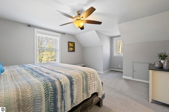 9086 N Tottenham Dr, Traverse City, MI 49685 - bedroom featuring a ceiling fan, vaulted ceiling, baseboards, a baseboard radiator, and light carpet