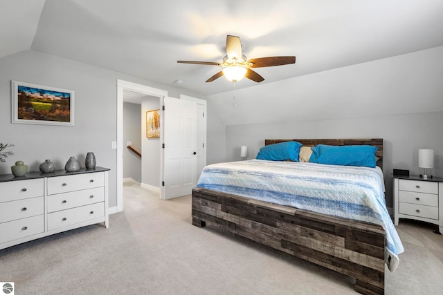 9086 N Tottenham Dr, Traverse City, MI 49685 - bedroom featuring baseboards, ceiling fan, vaulted ceiling, and light carpet