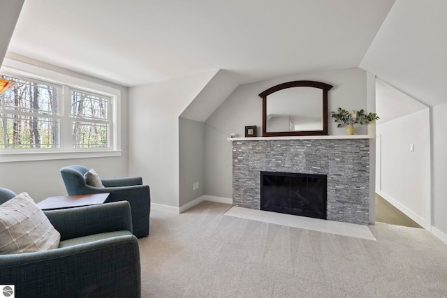 9086 N Tottenham Dr, Traverse City, MI 49685 - living area with carpet floors, baseboards, a stone fireplace, and lofted ceiling