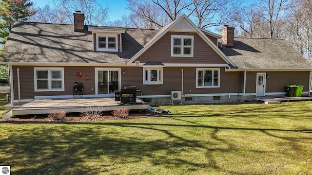 9086 N Tottenham Dr, Traverse City, MI 49685 - back of house with a lawn, roof with shingles, a chimney, and a deck