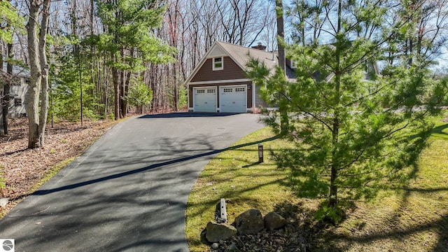 9086 N Tottenham Dr, Traverse City, MI 49685 - garage with aphalt driveway