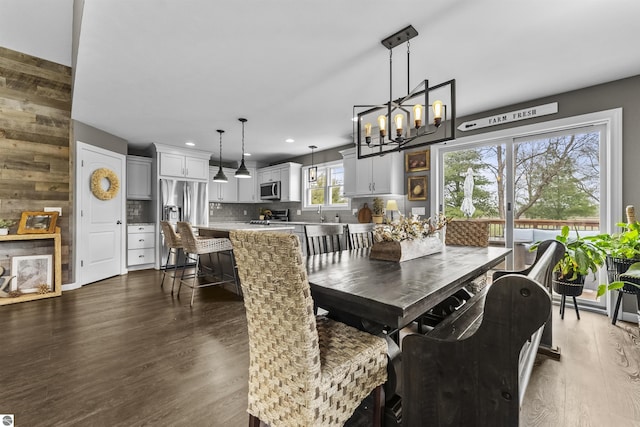 dining room featuring recessed lighting, dark wood finished floors, and a notable chandelier