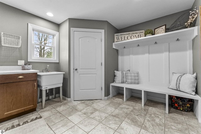 mudroom with recessed lighting and baseboards