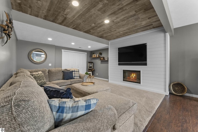 living area with a large fireplace, recessed lighting, baseboards, wooden ceiling, and wood finished floors